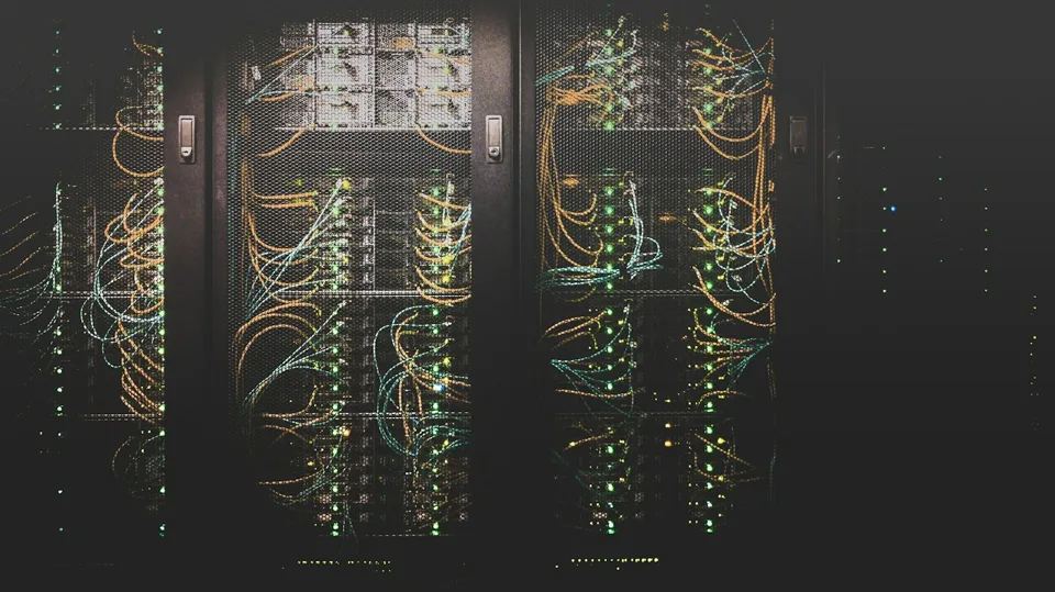 Data-centre server racks with network cabling.